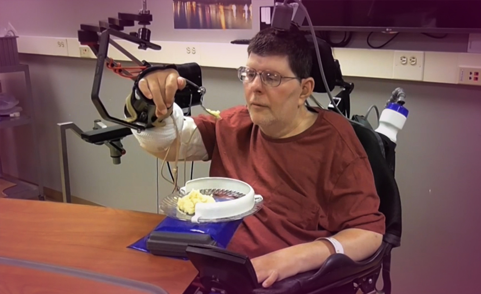 Paralyzed man uses experimental device
